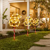 Luzes LED solares para caminhos com rosto de Papai Noel e doces